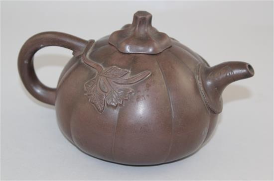 A Chinese Yixing melon-shaped teapot and cover, 19th / 20th century, length 18cm